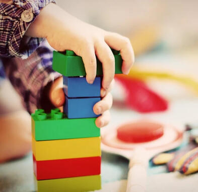 Kid placing legos